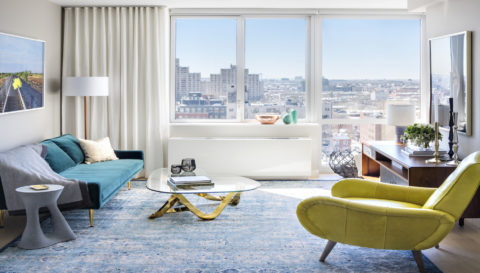 Living room with colorful furniture and views of brooklyn