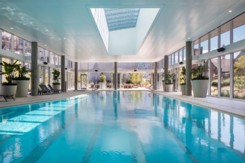 indoor pool with floor to ceiling retractable windows