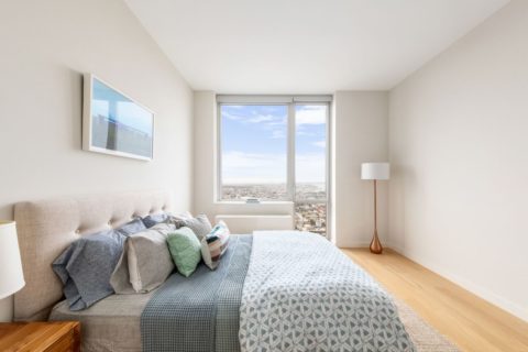 spacious bedroom with views of brooklyn