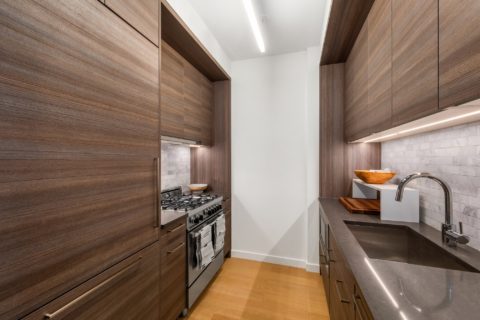 galley kitchen with wood finishes